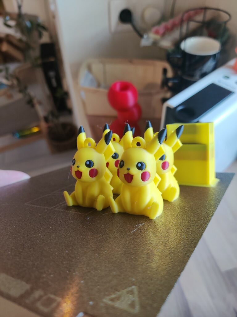 Row of yellow Pikachu toy figures lined up on a brown countertop with a blurred kitchen in the background.