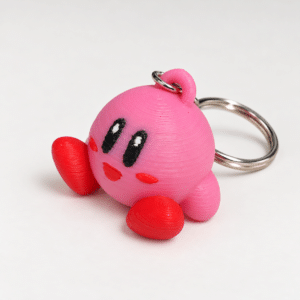 Porte-clé Kirby rose - vue principale ‣ Atelier 34 Porte-clé Kirby rose imprimé en 3D, vue principale.